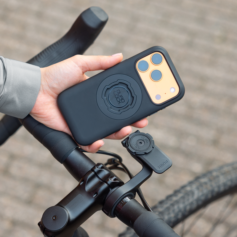 Hand holding Quad Lock MAG iPhone case.