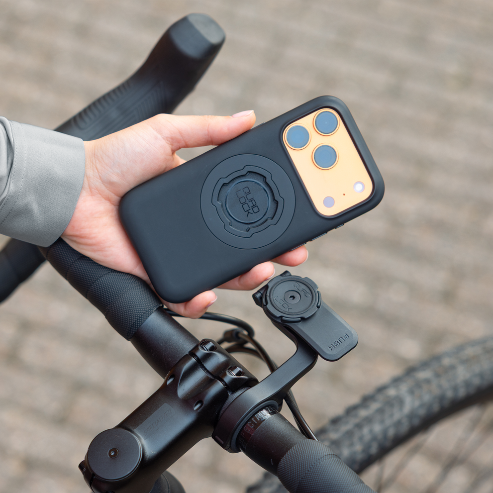 Hand holding Quad Lock MAG iPhone case.