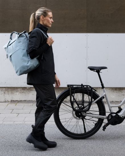 Thule Shield backpack with InLock 23L worn next to a bike