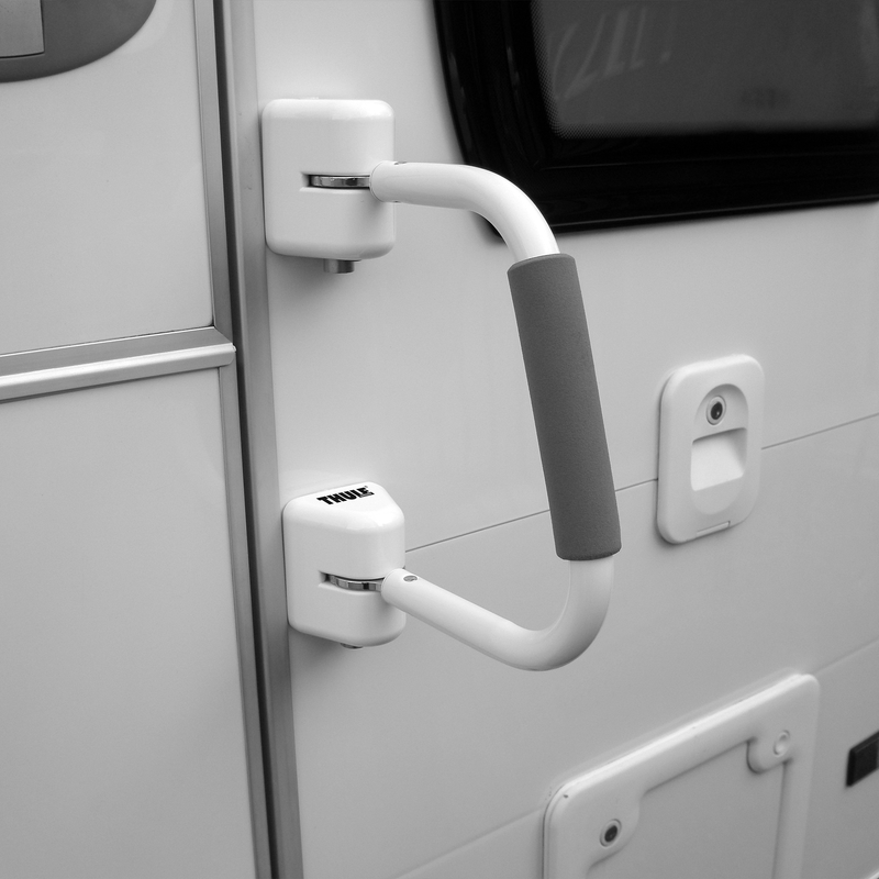 A picture of the Thule Security Handrail attached to the door of a motorhome.