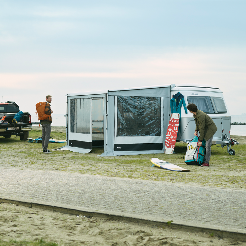 A van parked by a street with a Thule Residence G3 Eriba van awning tent.
