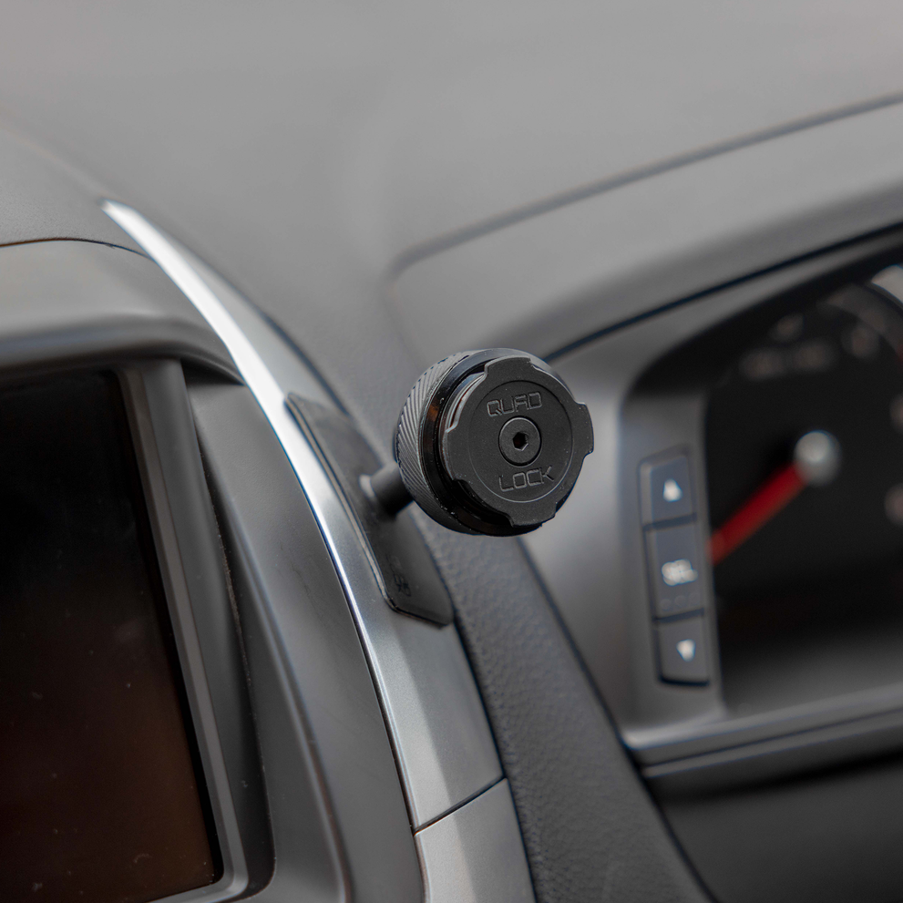 Quad Lock car mount attached to dashboard trim.