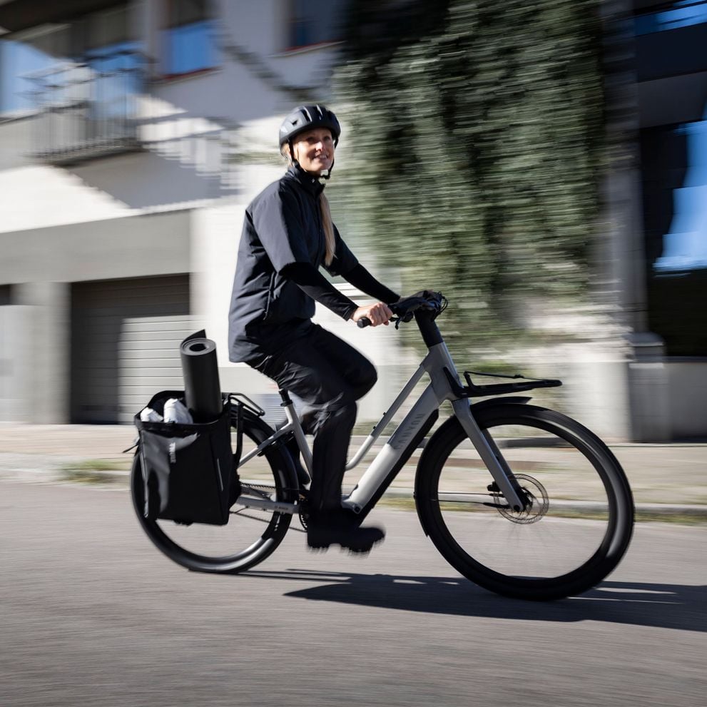 Cyclist riding with a Thule Chasm bag mounted on the rear rack.