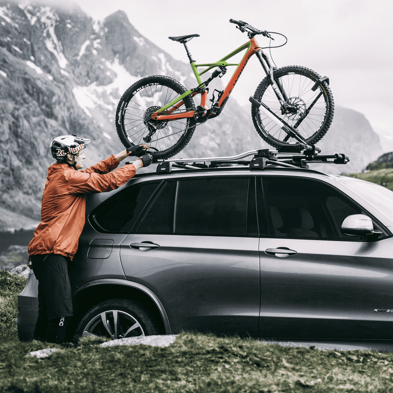 Panoramic view of a car with bikes mounted on a Thule UpRide.