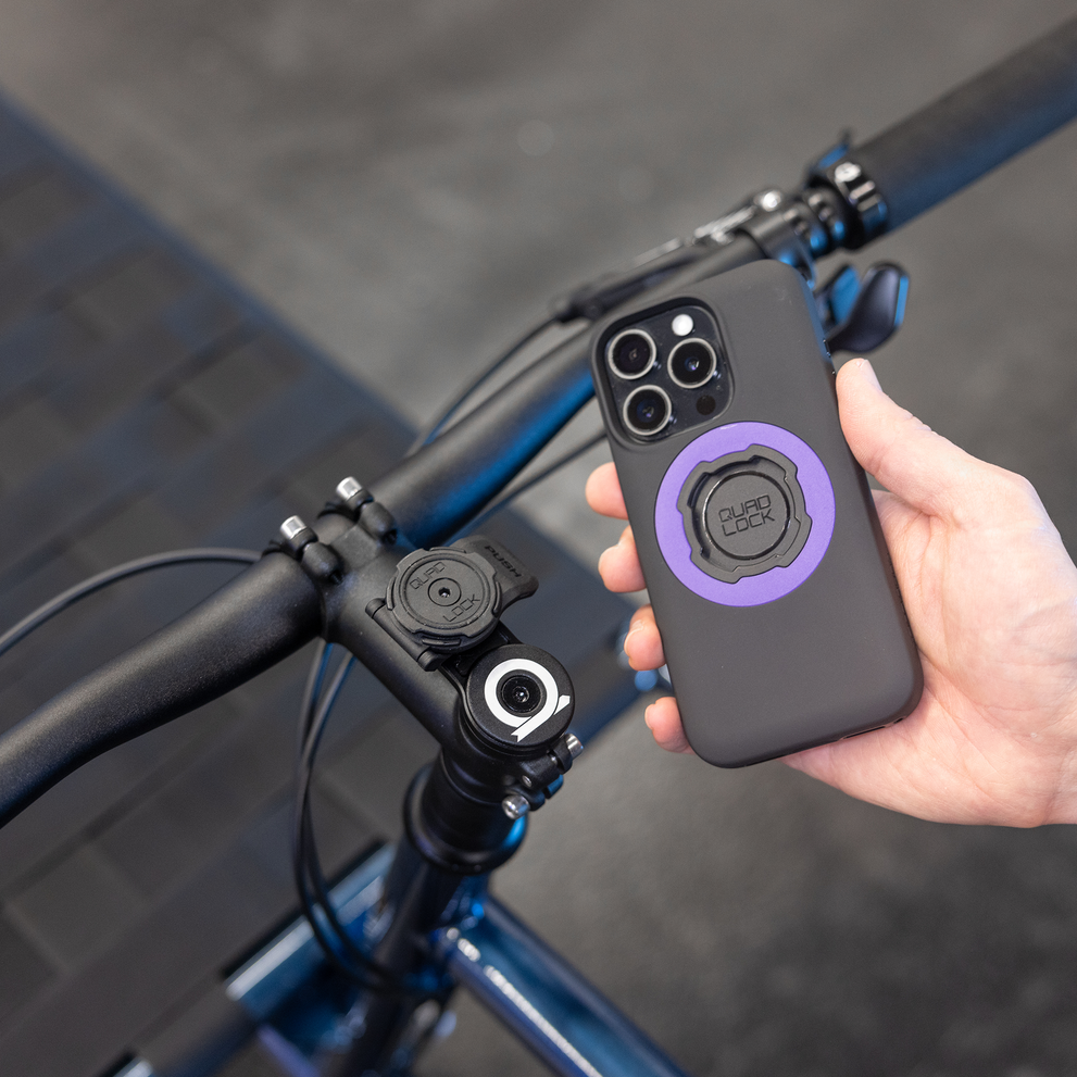 Phone with Quad Lock case near stem cap mount.