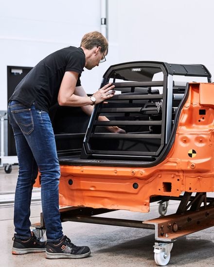 Safety for everyone - A man testing out a dog crate in test center