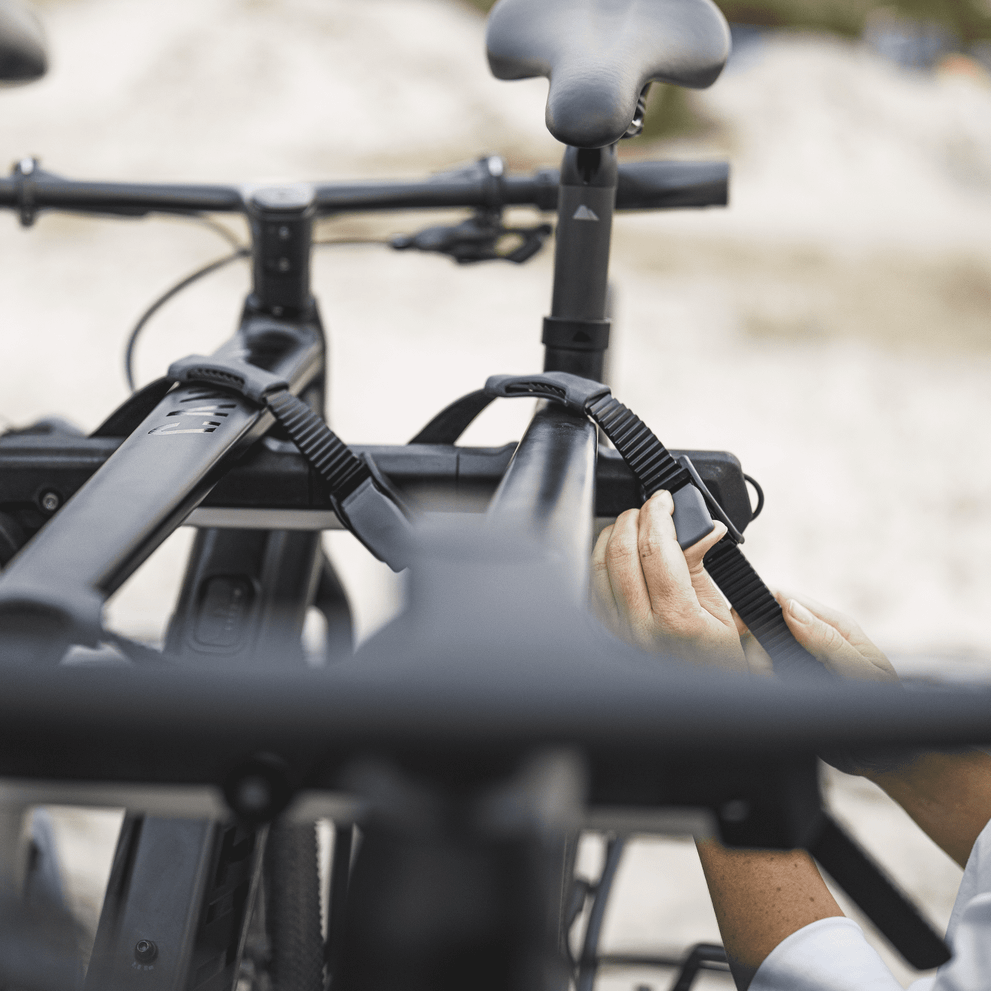 A close-up of the bike installed on the Thule OutWay Platform hanging trunk bike rack.