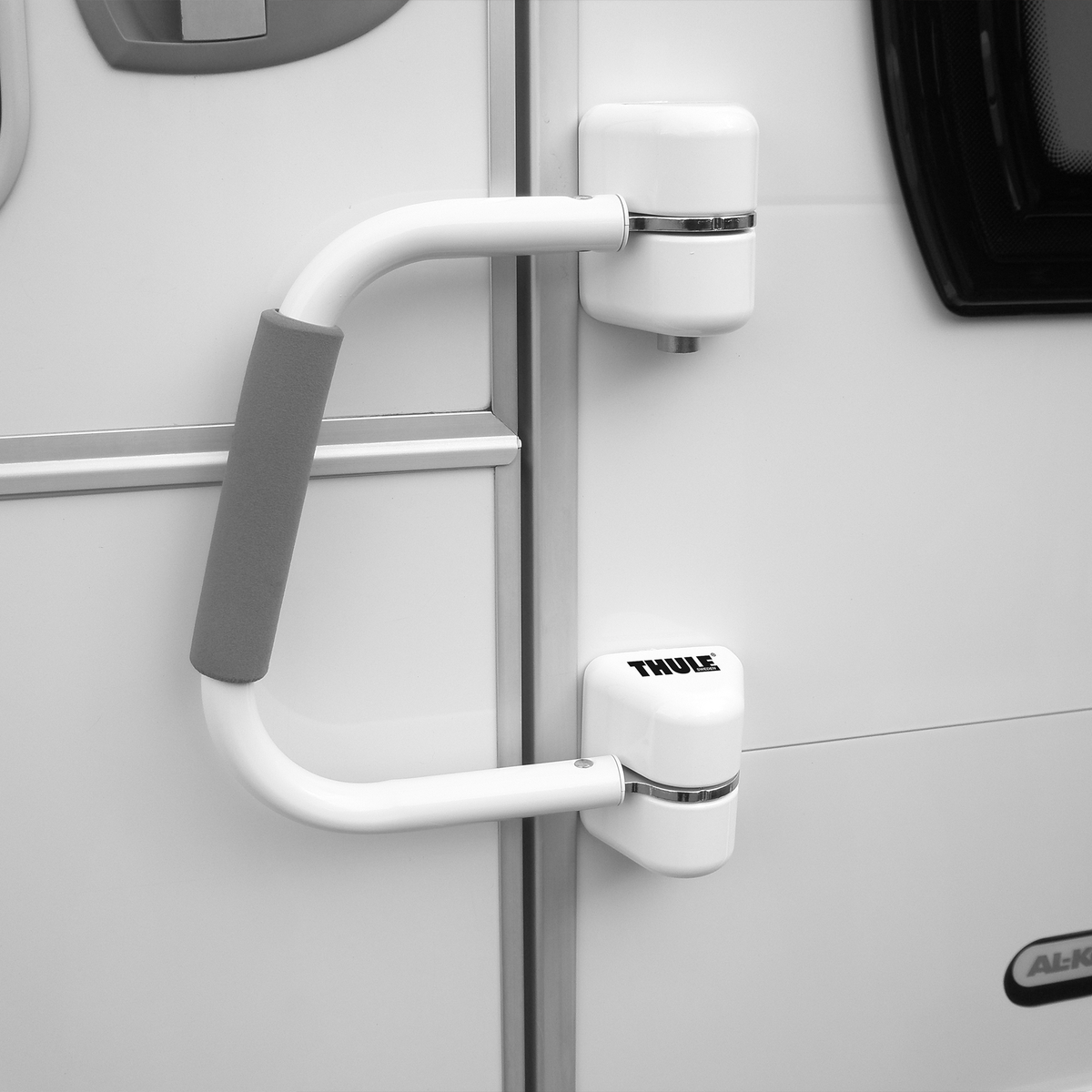 A picture of the Thule Security Handrail attached to the door of a motorhome.
