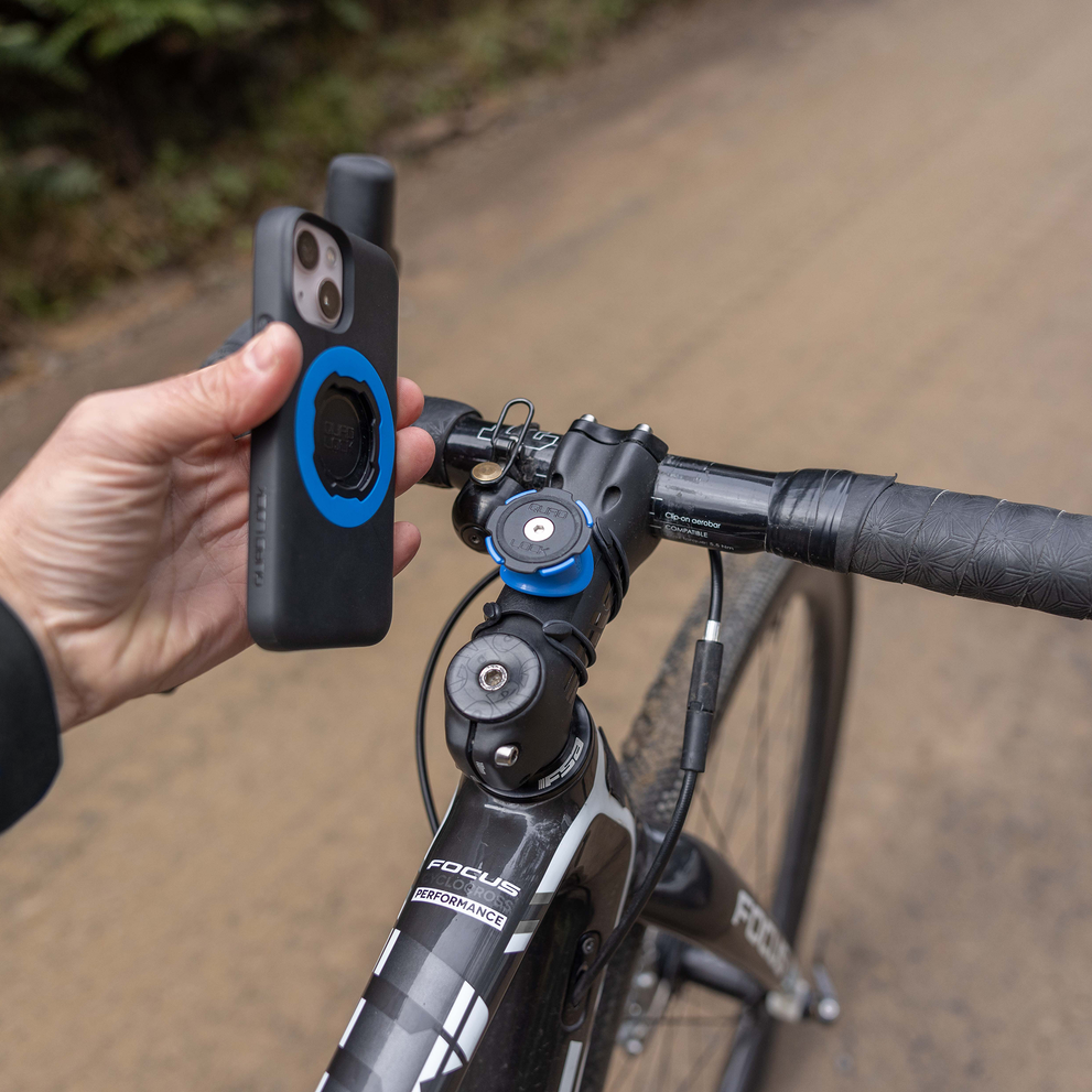 Phone being attached to Quad Lock handlebar mount.