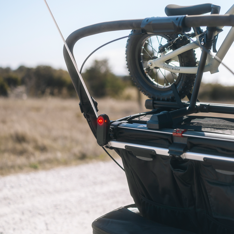 Thule mount for Garmin Varia rearview radar attached to the rear of a bike trailer carrying a bicycle.