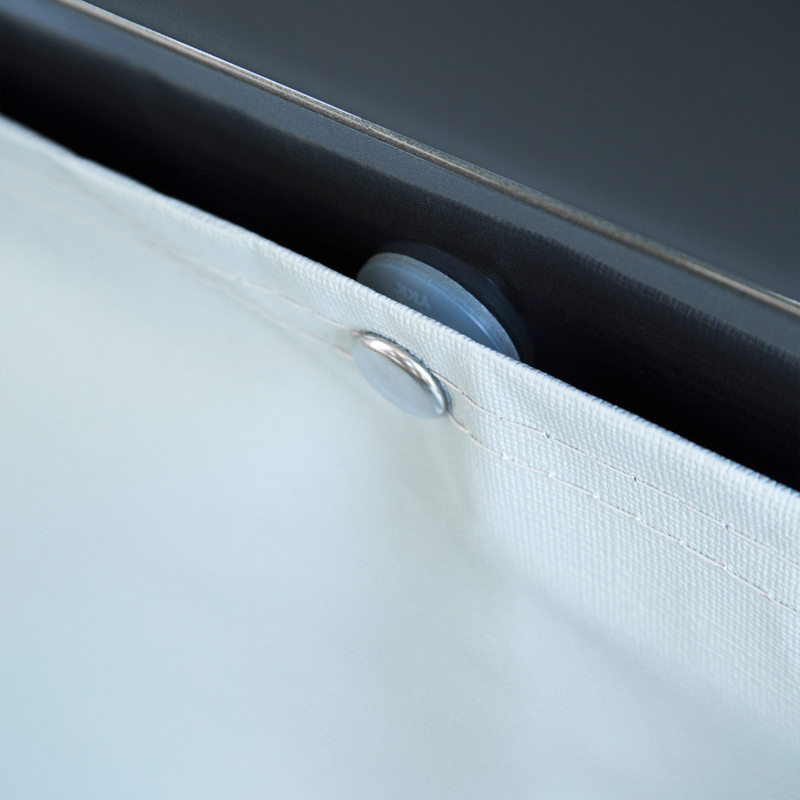 A close-up of someone placing a white Thule Wheelcover on an RV.