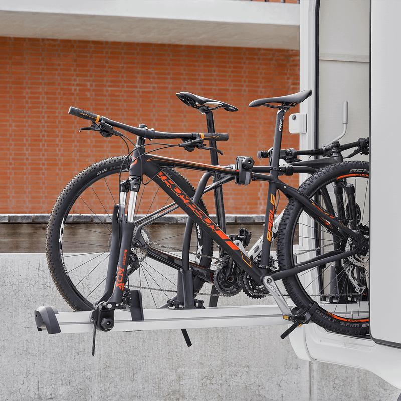 Two bikes are loaded inside a motorhome bike rack using the Thule Forkmount Adapter Kit Quick Release.