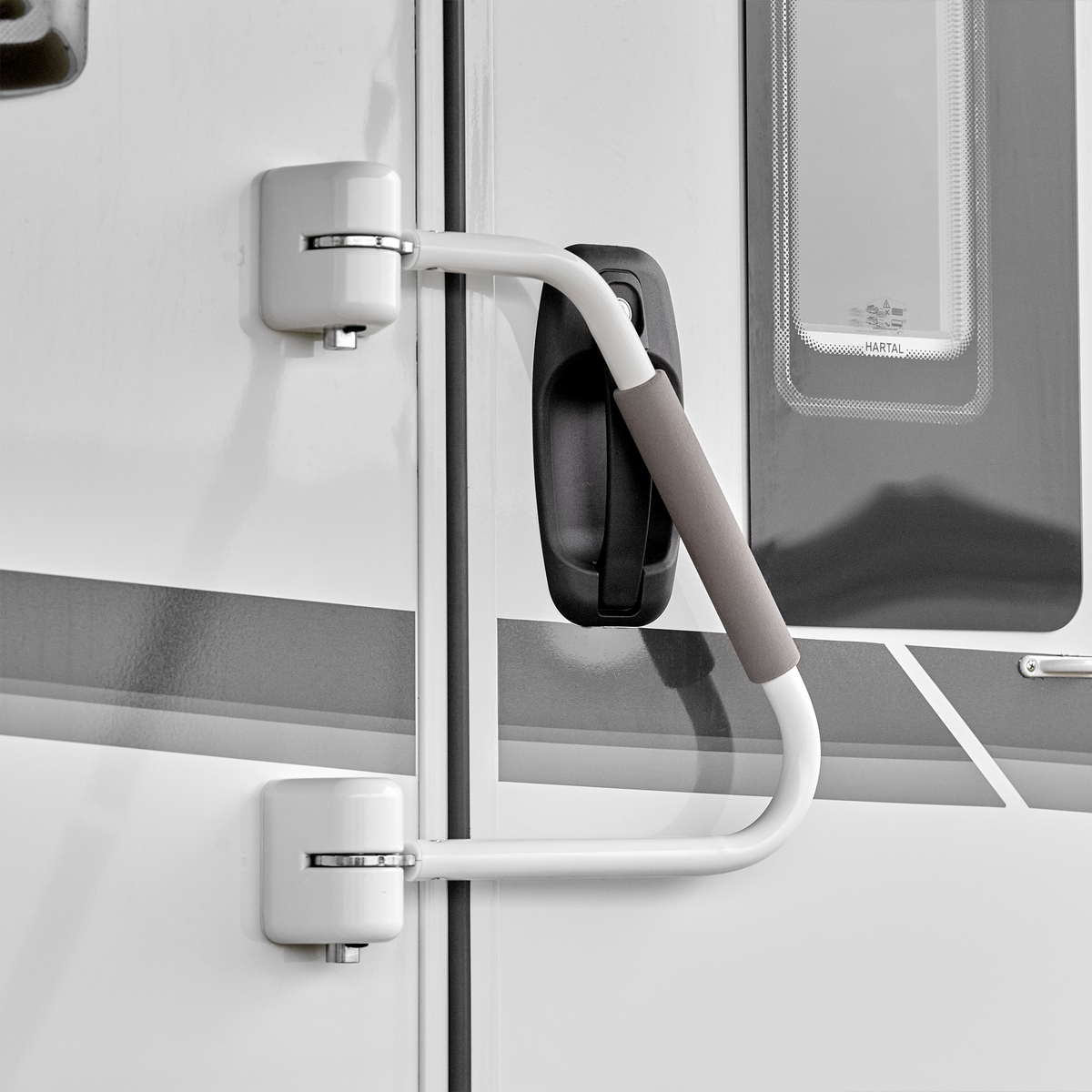 A picture of the Thule Security Handrail attached to the door of a motorhome.