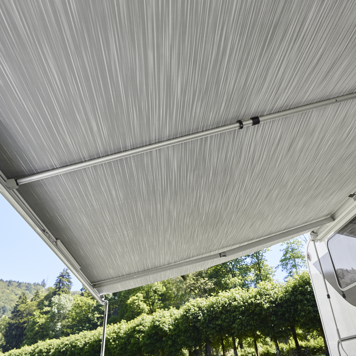 A Thule Tension Rafter G2 connected to a gray awning attached to an RV.
