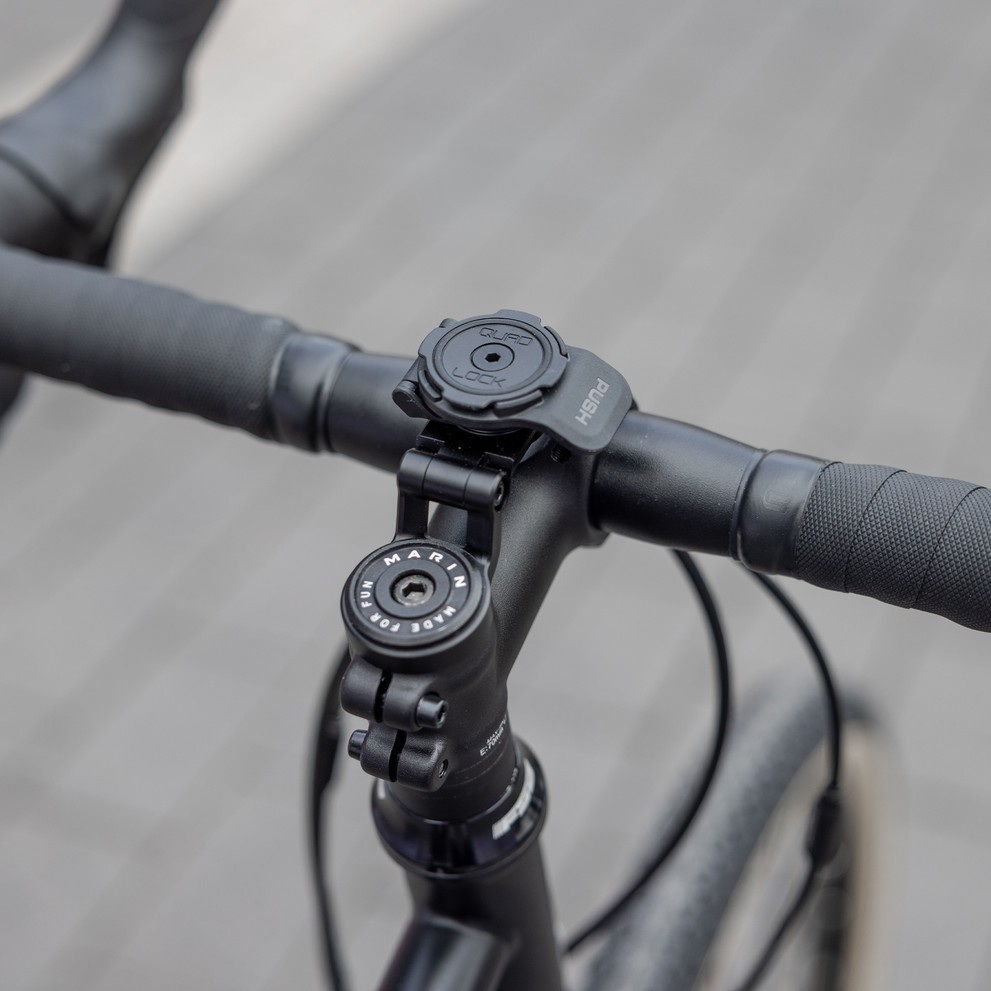 Quad Lock adjustable stem cap mount installed on a bicycle stem, viewed from above.