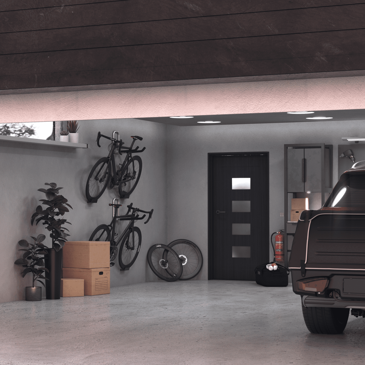 A car is parked in the garage and there are bikes hanging on the Thule Wall hanger.