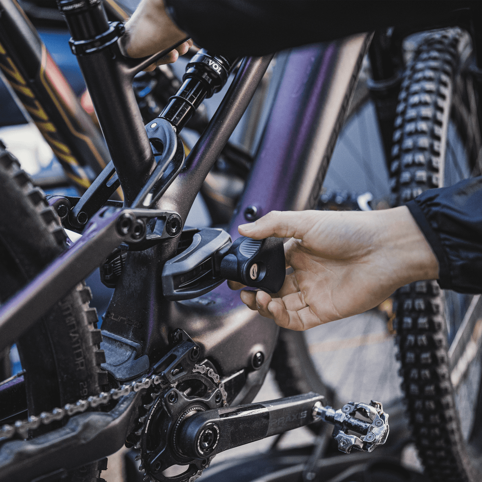 Closeup of hands attaching a bike to a Thule EasyFold XT.