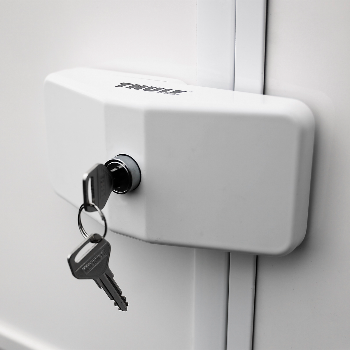 A key is inside a Thule Door Lock caravan lock.