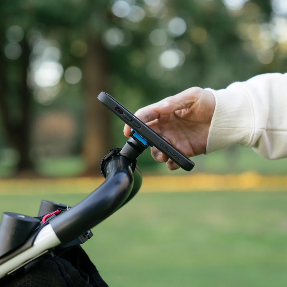 Phone being attached to Quad Lock strap mount.