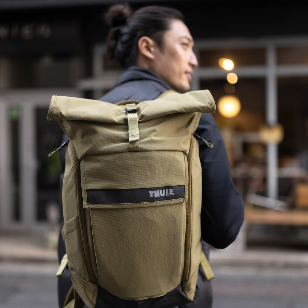 Man with Thule Paramount 24L backpack crossing the street