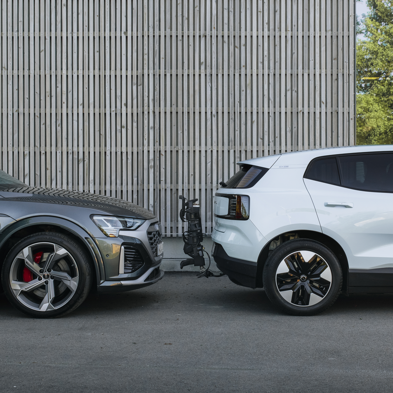 A tilted up Thule OutPace bike carrier attached to a car making it easy to park.