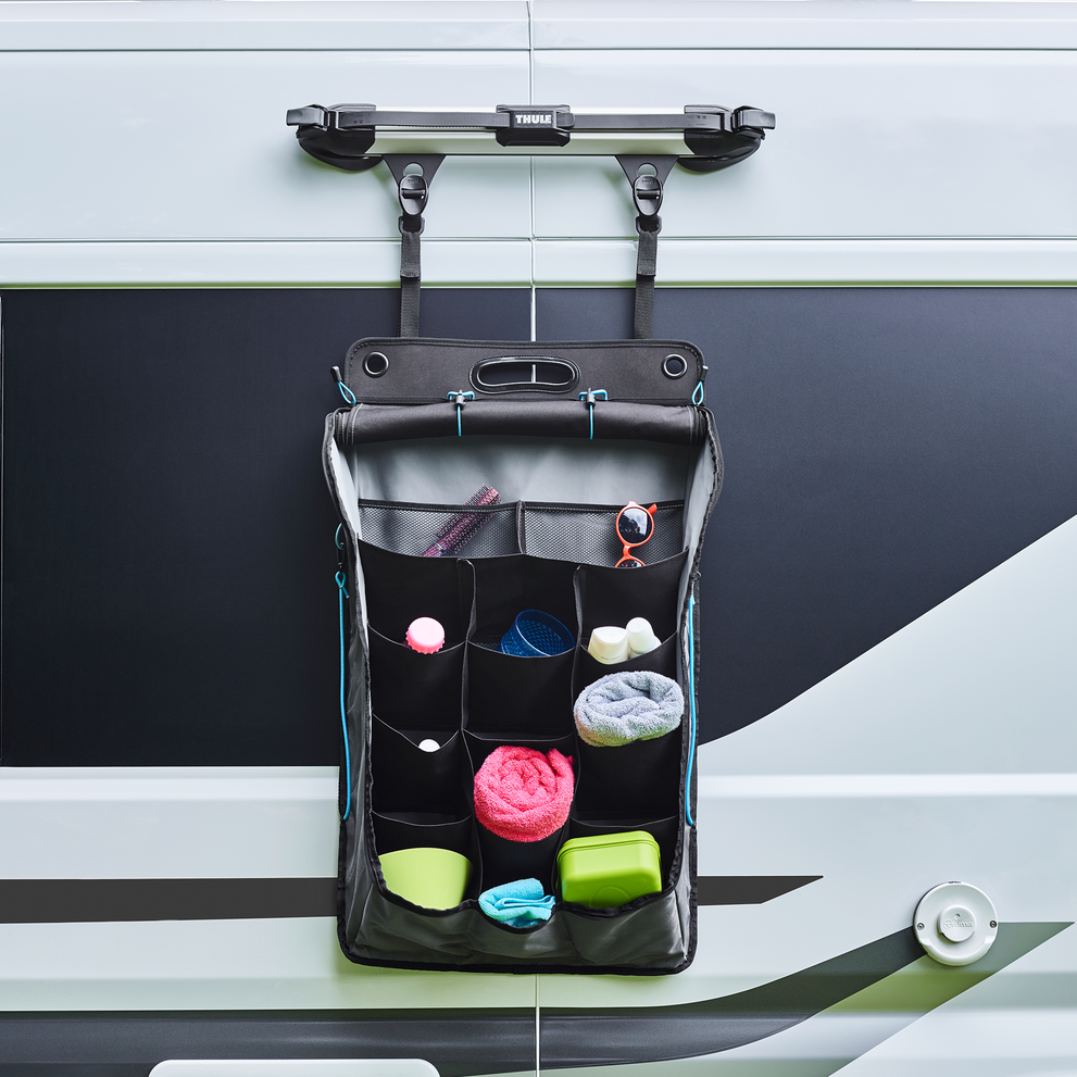 A motorhome organizer is attached using a Thule Ladder Fixation Kit.