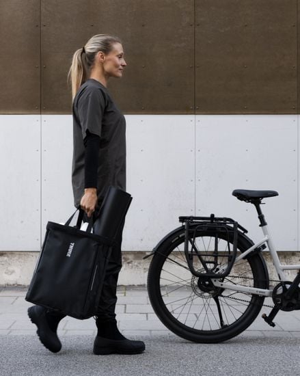 Thule Chasm cargo bin with InLock 25L carried next to a bike