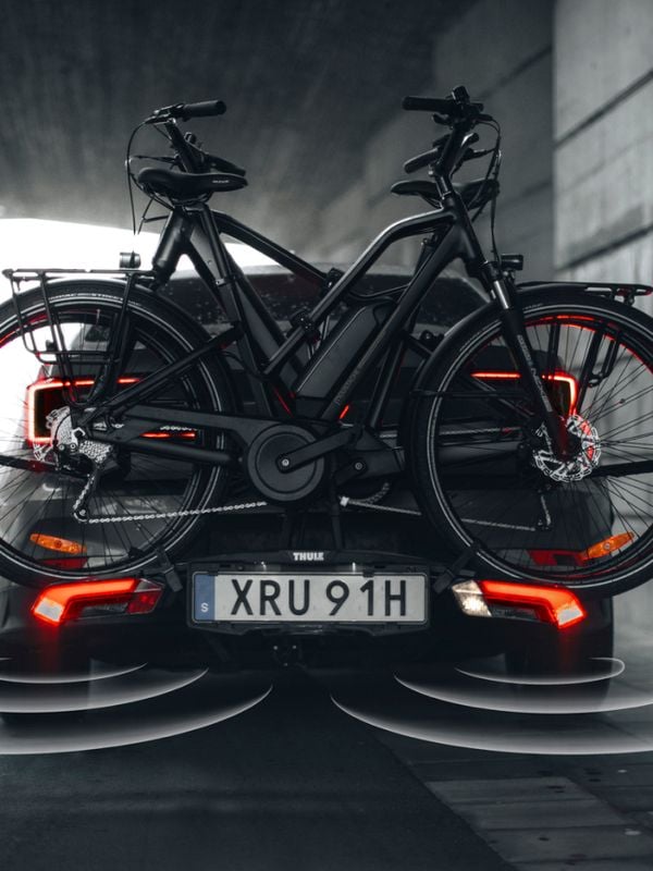 A car mounted with a bike carrier, standing in parking mode. Alerting that something is getting closer.