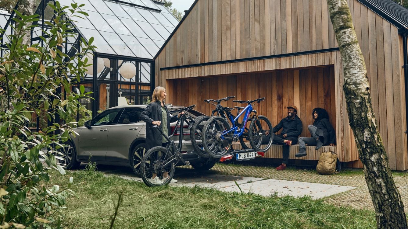 Thule bike carriers outside a house loaded with 3 bikes