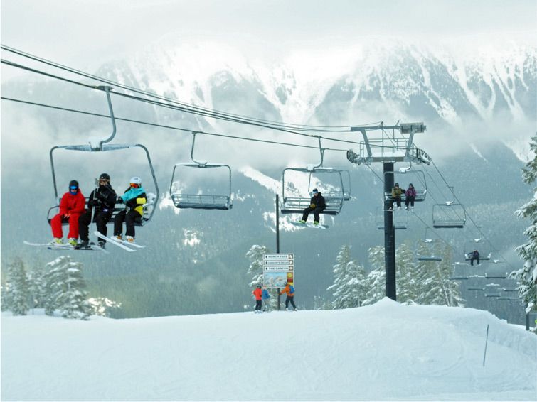 A ski lift at Mount Baker USA with the massive tree-covered slopes in the background.