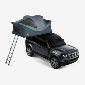 A rooftop tent with a gray background. 