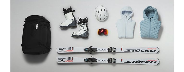 A flat lay of the Thule RoundTrip boot bag and the skis, ski boots, helmets and jacket you can fit inside.