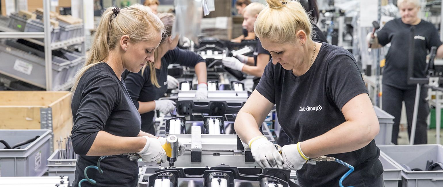 Two women working on Thule products