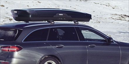 Close-up of a vehicle with a Thule roof cargo box.