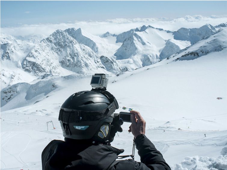 A skier at Schlick in Austria takes a photo of the beautiful snowy mountains.