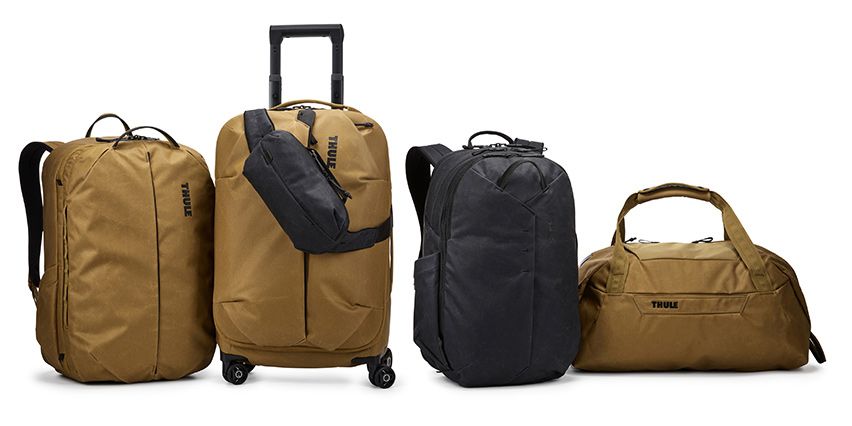 The Thule Aion luggage collection of backpacks, duffel, sling bag and suitcase against a white background.