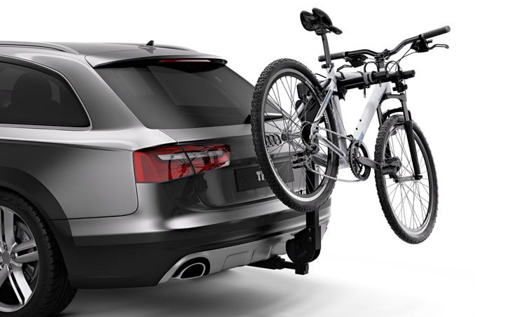 A Thule Camber 4 hitch bike rack installed on a car carrying one bike.