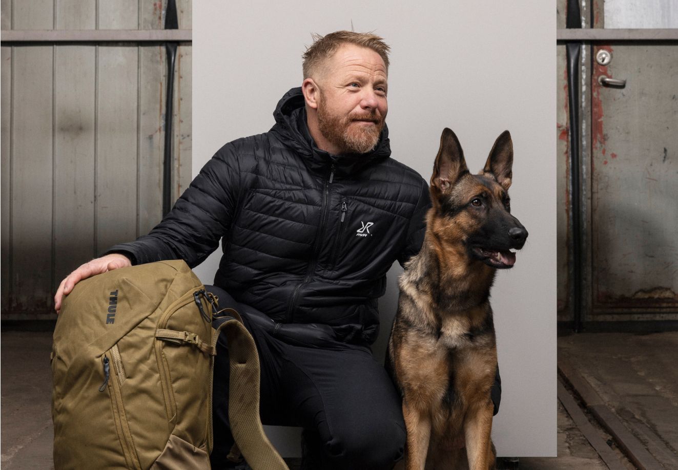 Fredrik Steen posa com o seu pastor alemão e uma mochila Thule.