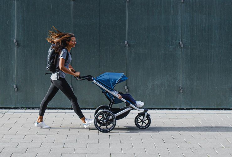 Wind in hair mom walking with stroller Thule Urban Glide 2 Majolica Blue