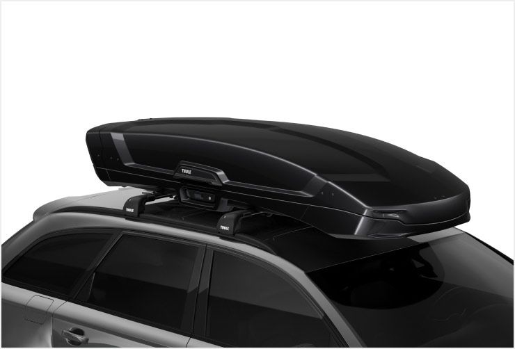 A zoomed in picture of the Thule Vector roof cargo box on top of a car.