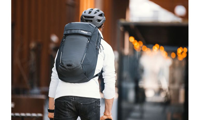 A close-up of a bike commuter with a Thule Paramount bike commuter backpack.