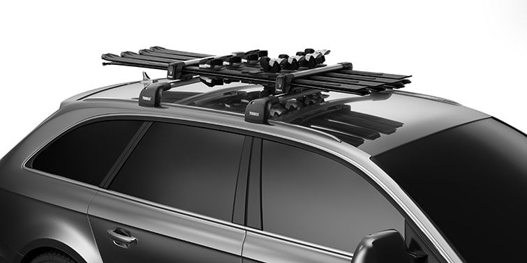 A close-up of Thule ski rack on a car with a white background.