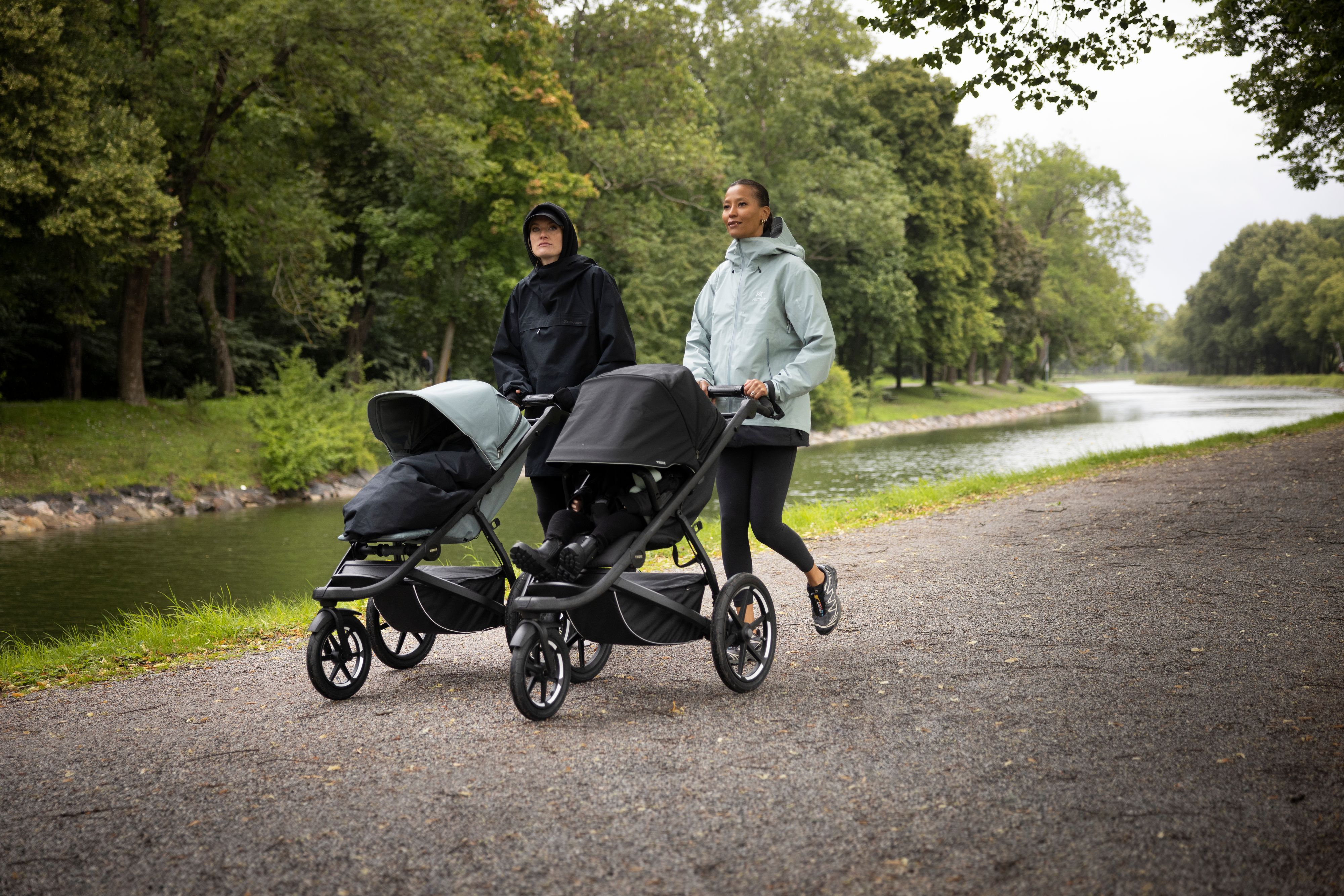Caroline Hjelt and Aino Jaw of Icona Pop walking in a park with a Thule Urban Glide 3 jogging stroller each.