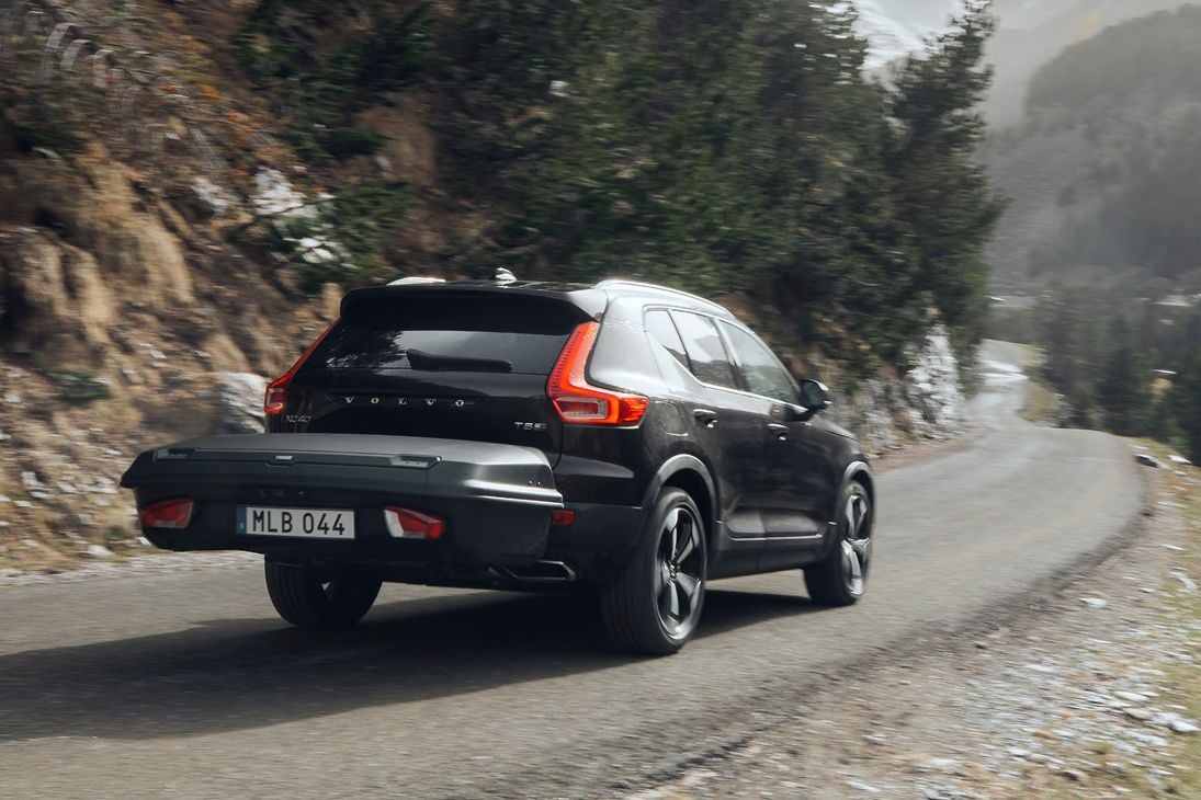 A black SUV with a mounted Thule Arcos is driving.