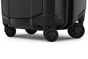 A close up of the wheels of Thule Revolve luggage with a white background. 