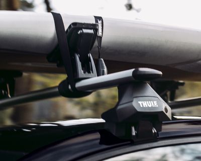 A close-up of a roof rack accessory component on top of a vehicle roof.