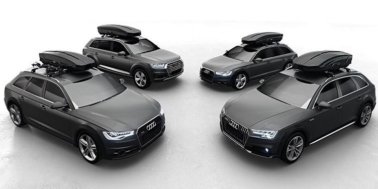 An image of four cars each with a car roof box and a white background.
