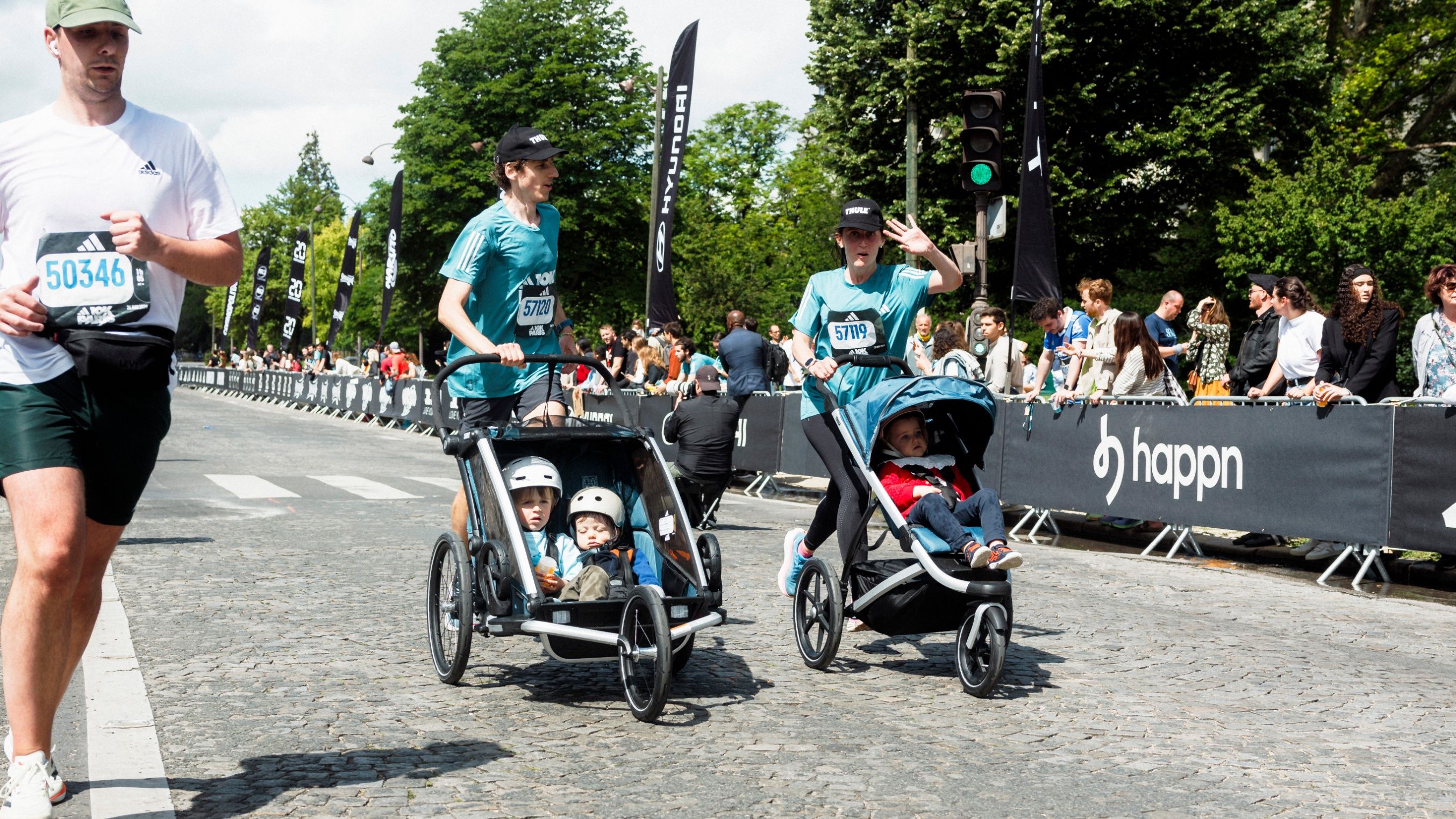 Partecipanti che corrono nella gara di passeggini Adidas 10K a Parigi con i passeggini Thule Urban Glide.