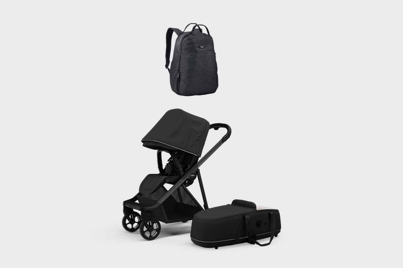 A picture a black Thule stroller and the stroller accessories you will need for a newborn and diaper changes.