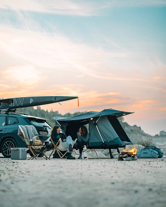 A towbar or a hitch mounted tent is mounted on a car.